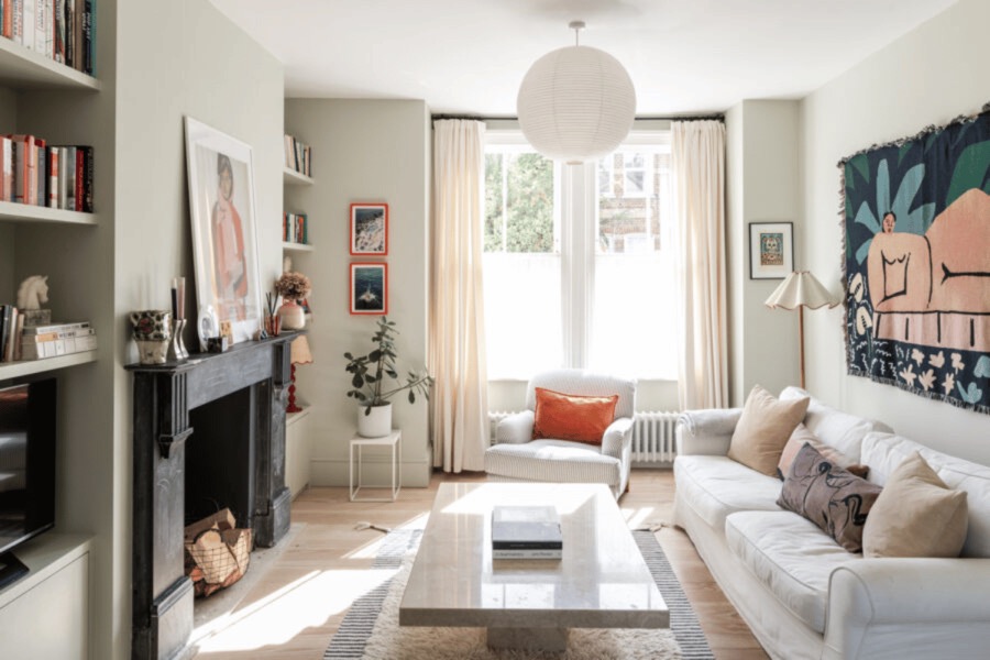 Sitting room styled by Studio 14 with a bay window, patterned artwork and layered textiles